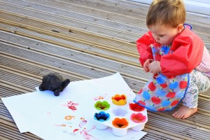 toddler playing with edible finger paints