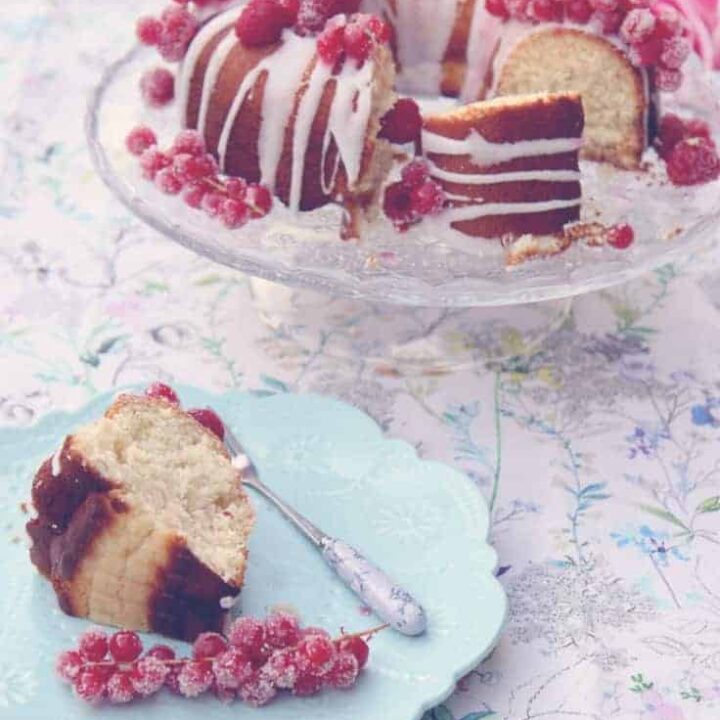 Lemon drizzle bundt cake with sugared raspberries and redcurrants