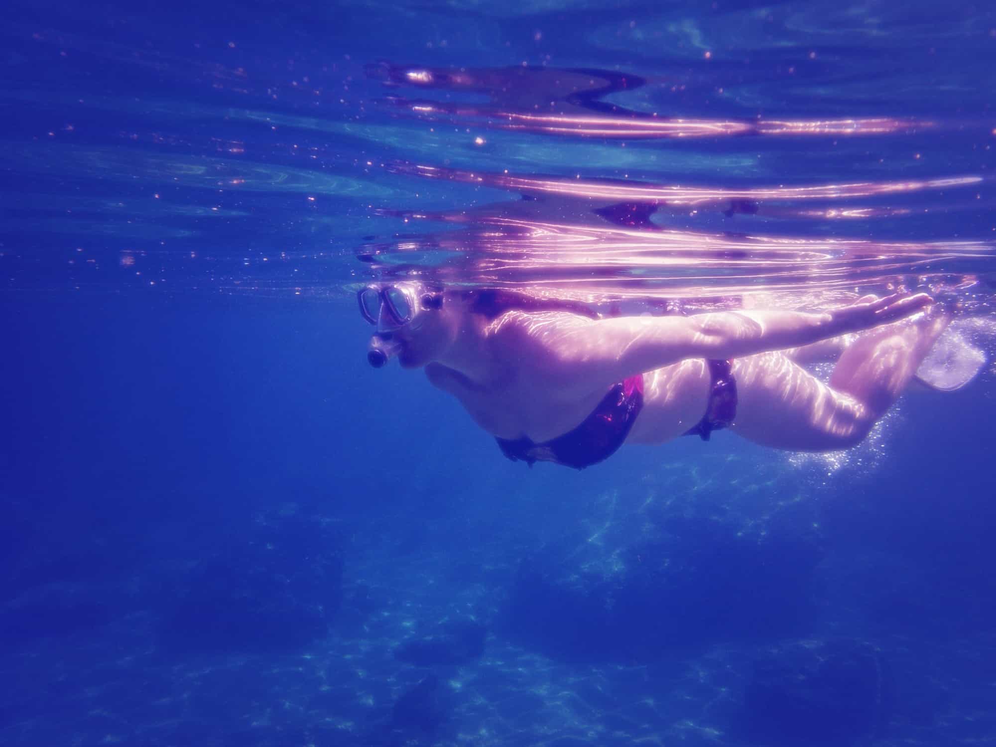 Lady underwater snorkelling