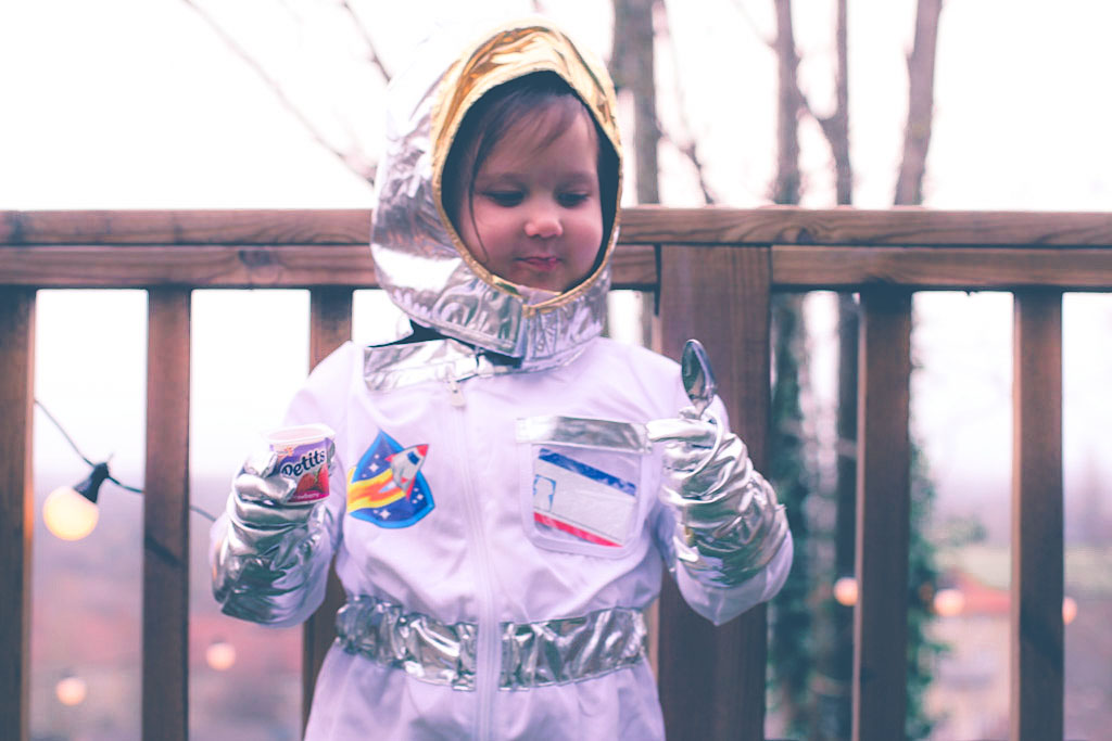 girl dressed as an astronaut eating petits filous