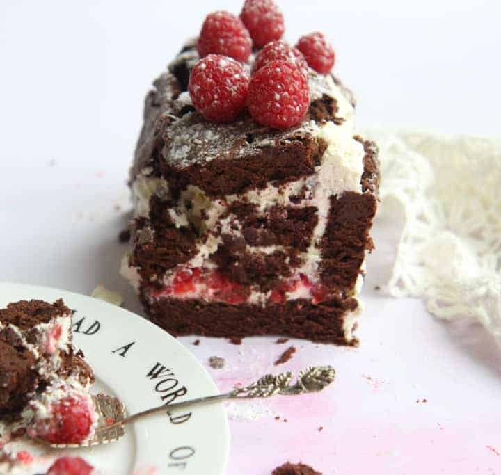 A chocolate roulade, decorated with raspberries