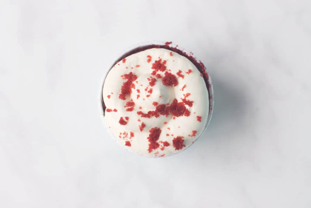 An overhead shot of a Weight Watchers red velvet cupcake with vanilla cream cheese frosting
