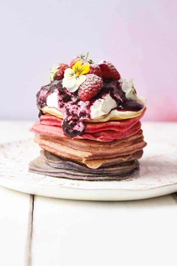Ombreé berry pancake stack topped with greek yoghurt and fresh fruit 