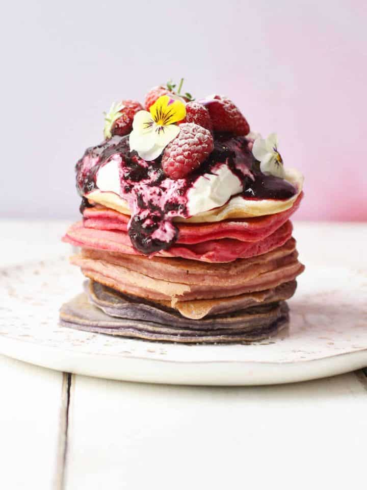 Ombreé berry pancake stack topped with greek yoghurt and fresh fruit