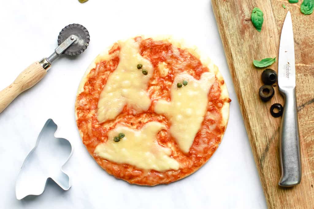 Overhead shot of a Halloween Pizza with cheese ghosts
