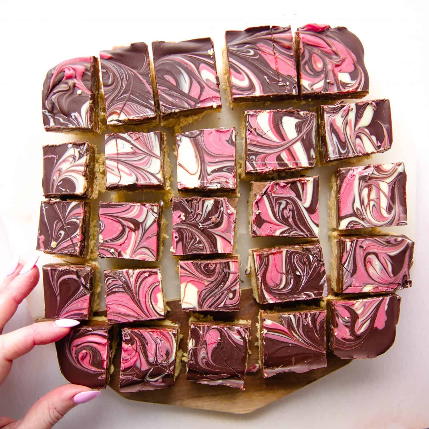 A slab of millionaire caramel shortbread cut into individual slices