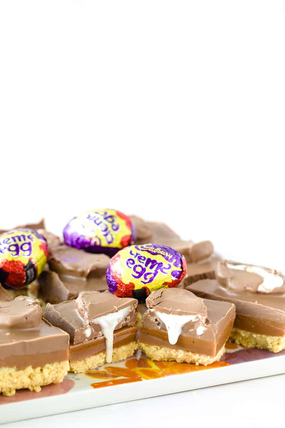 Slices of Creme egg caramel shortbread with Creme eggs on top