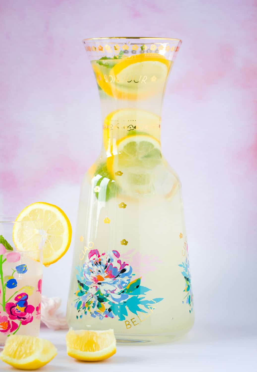 A pitcher of traditional lemon cordial with slices of lemon and sprigs of mint. 