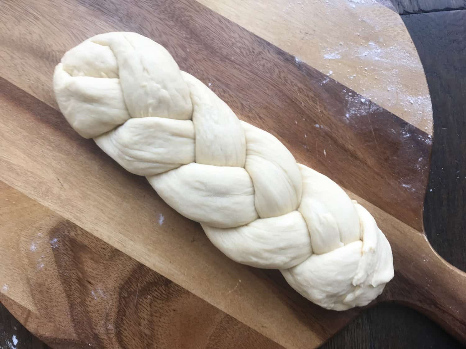 A brioche loaf that has been made into a plait
