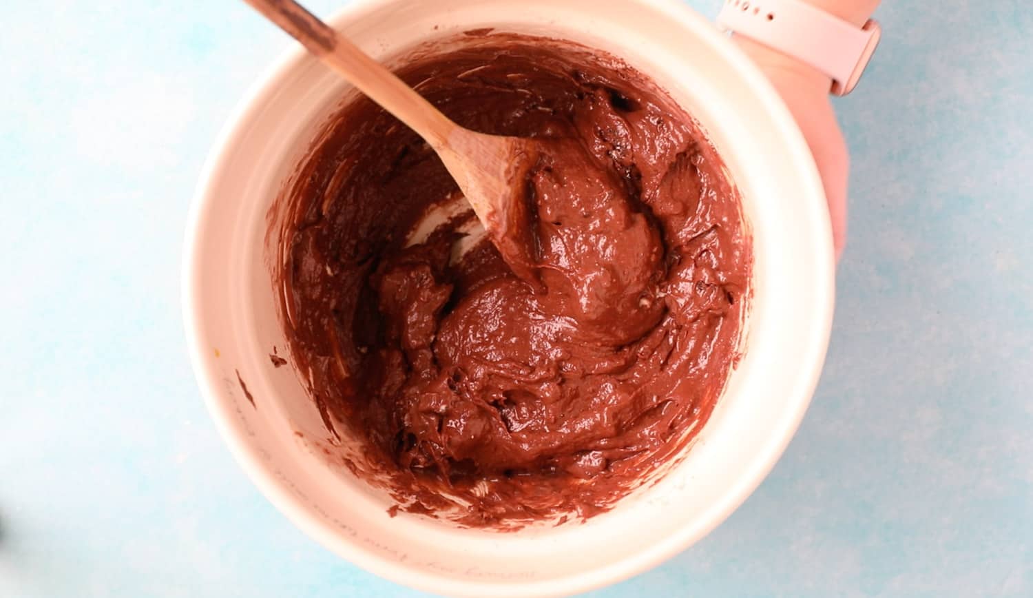 A mixing bowl with the ingredients for Oreo muffins