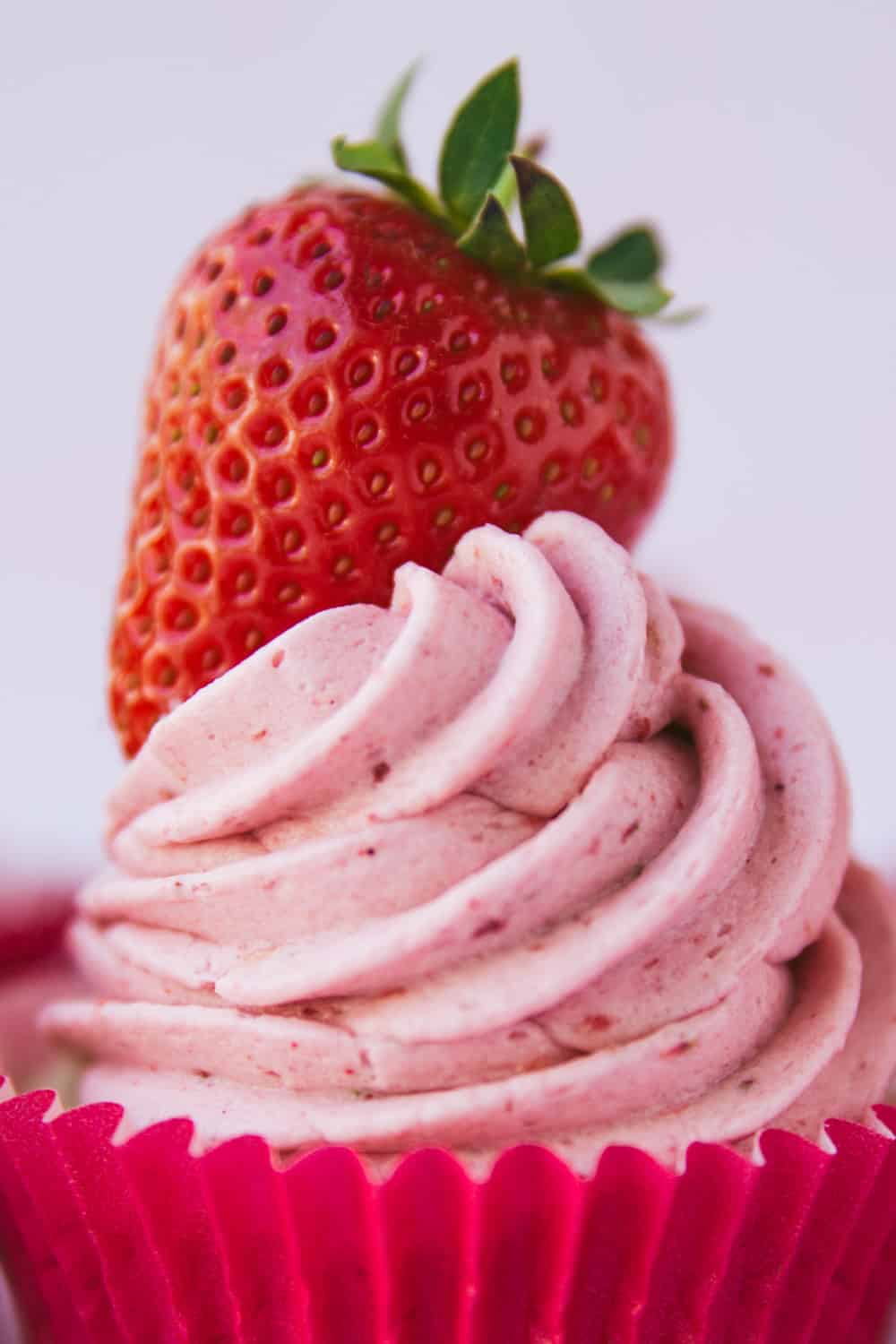 Pink buttercream icing a strawberry