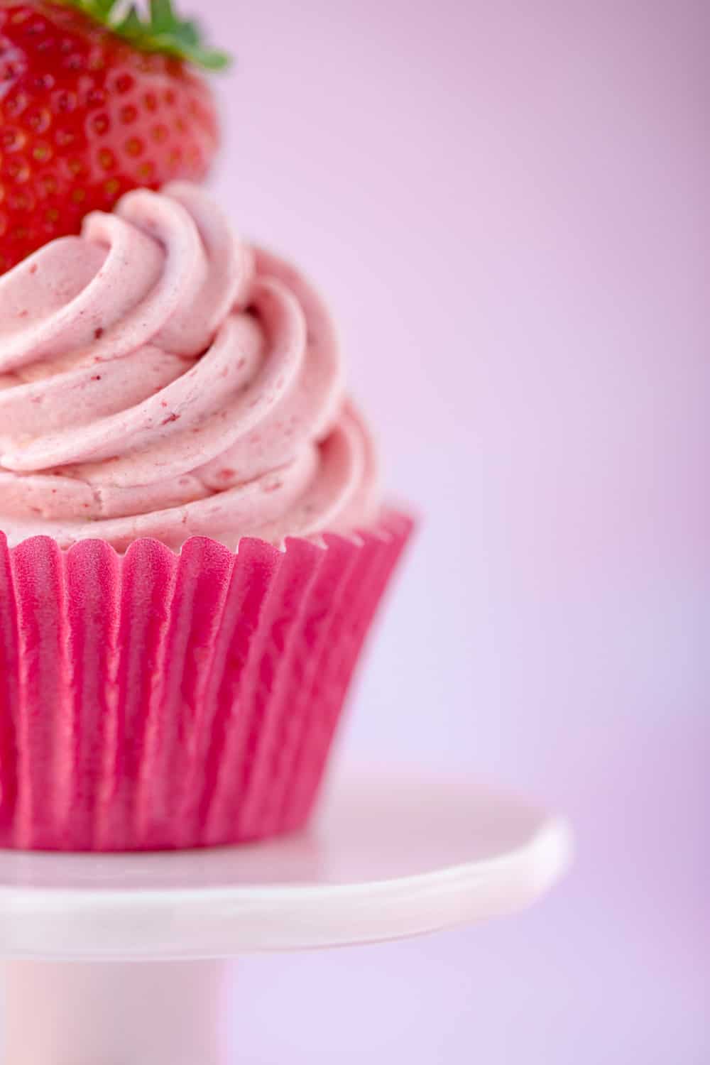 Side profile of a pink strawberry cupcake