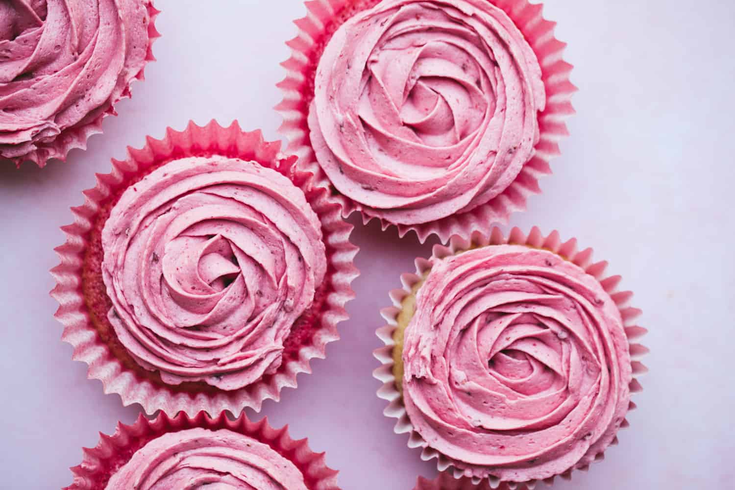 Cupcakes with pink buttercream roses piped on top