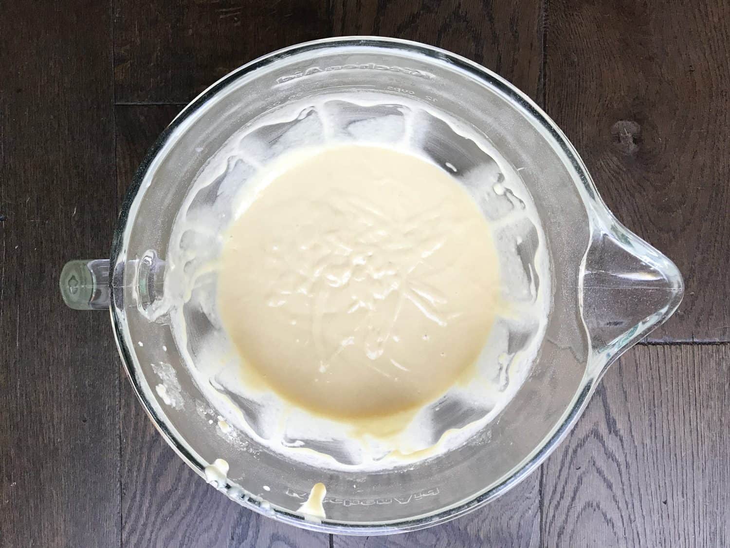 A mixing jug with vanilla cupcake mixture