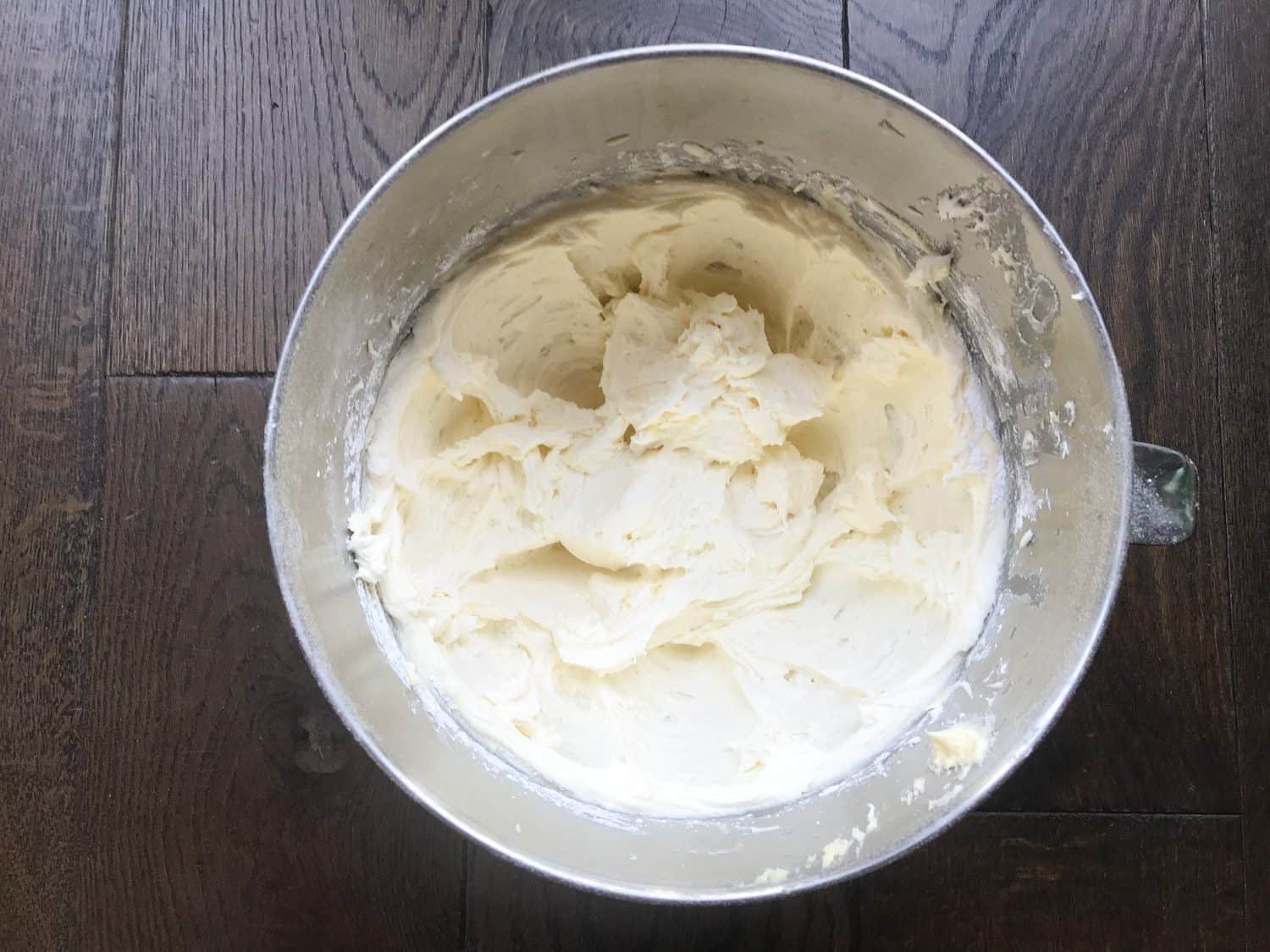 a mixing bowl filled with vanilla buttercream.