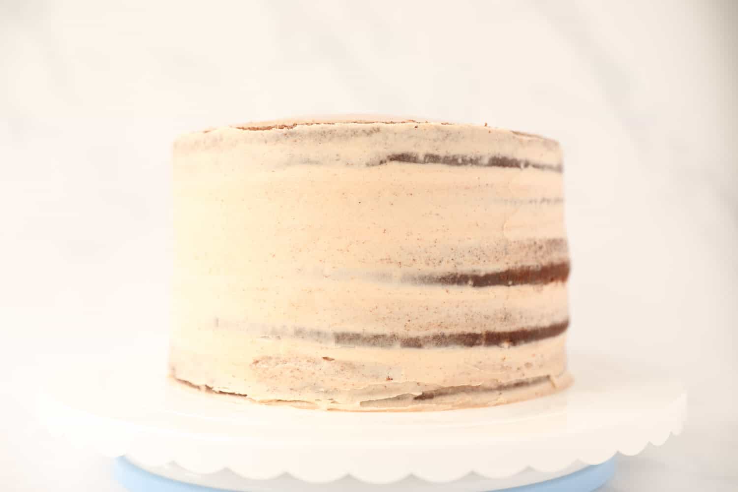 Side profile of a five layer chocolate cake that has been iced with nutella buttercream.