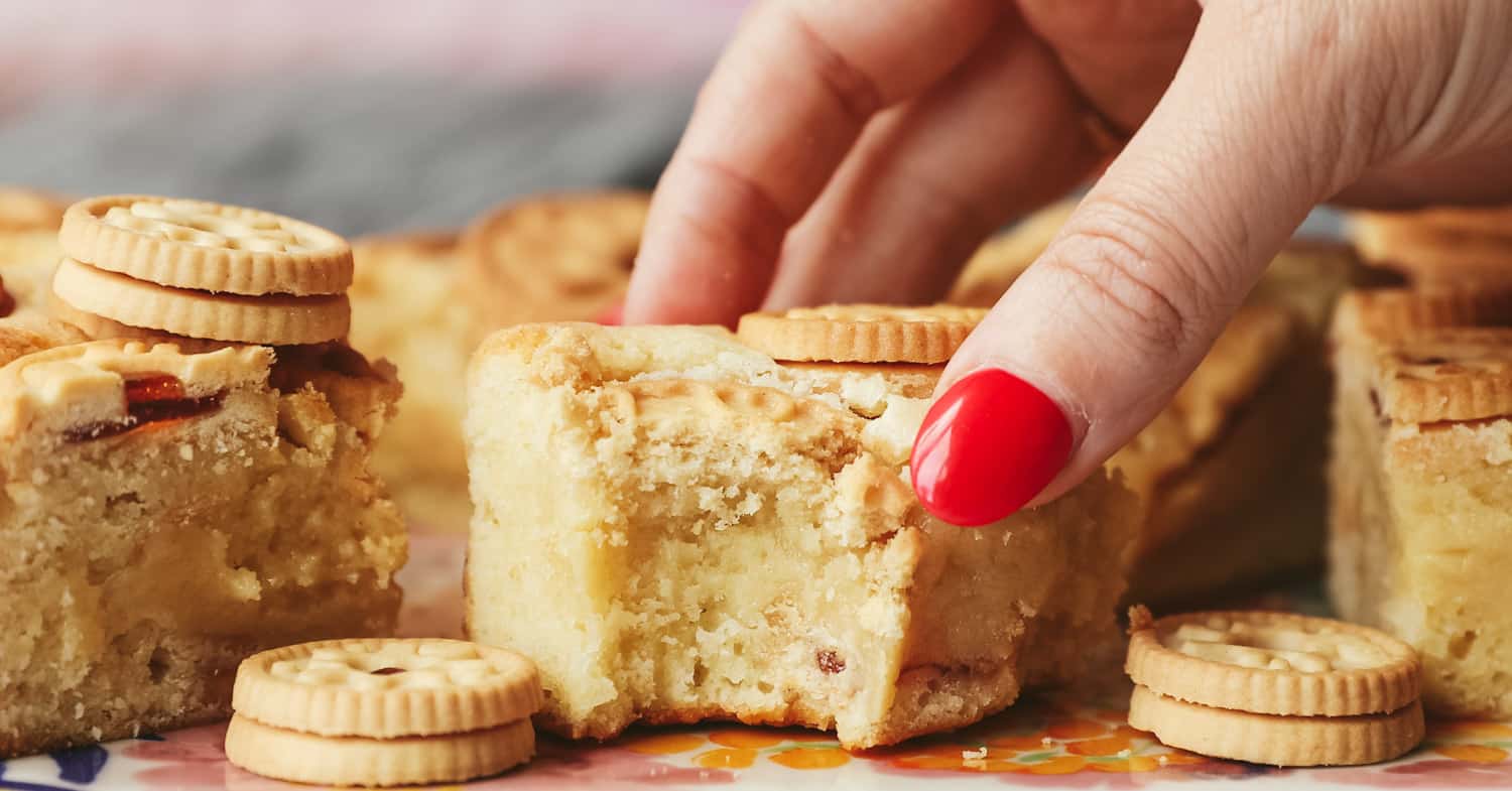 A piece of Jammie Dodger blondie with a bite taken out of it. 