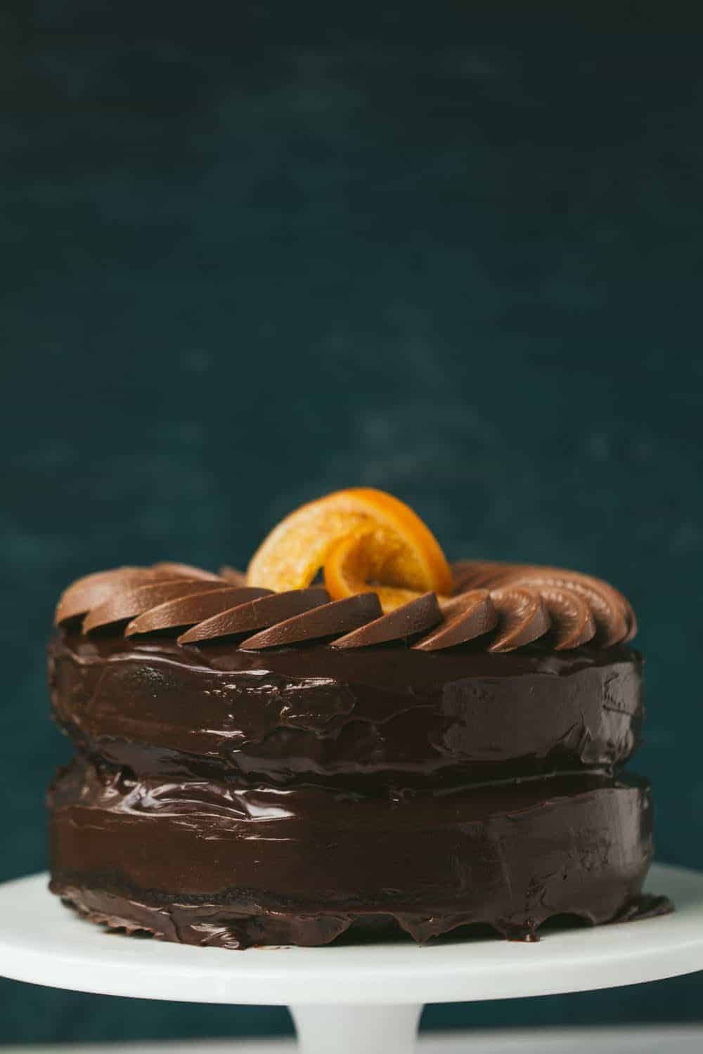 A 2 layer chocolate orange cake with a circle of Terry's chocolate orange segments decorating the top. There are 2 candied oranges in the centre.