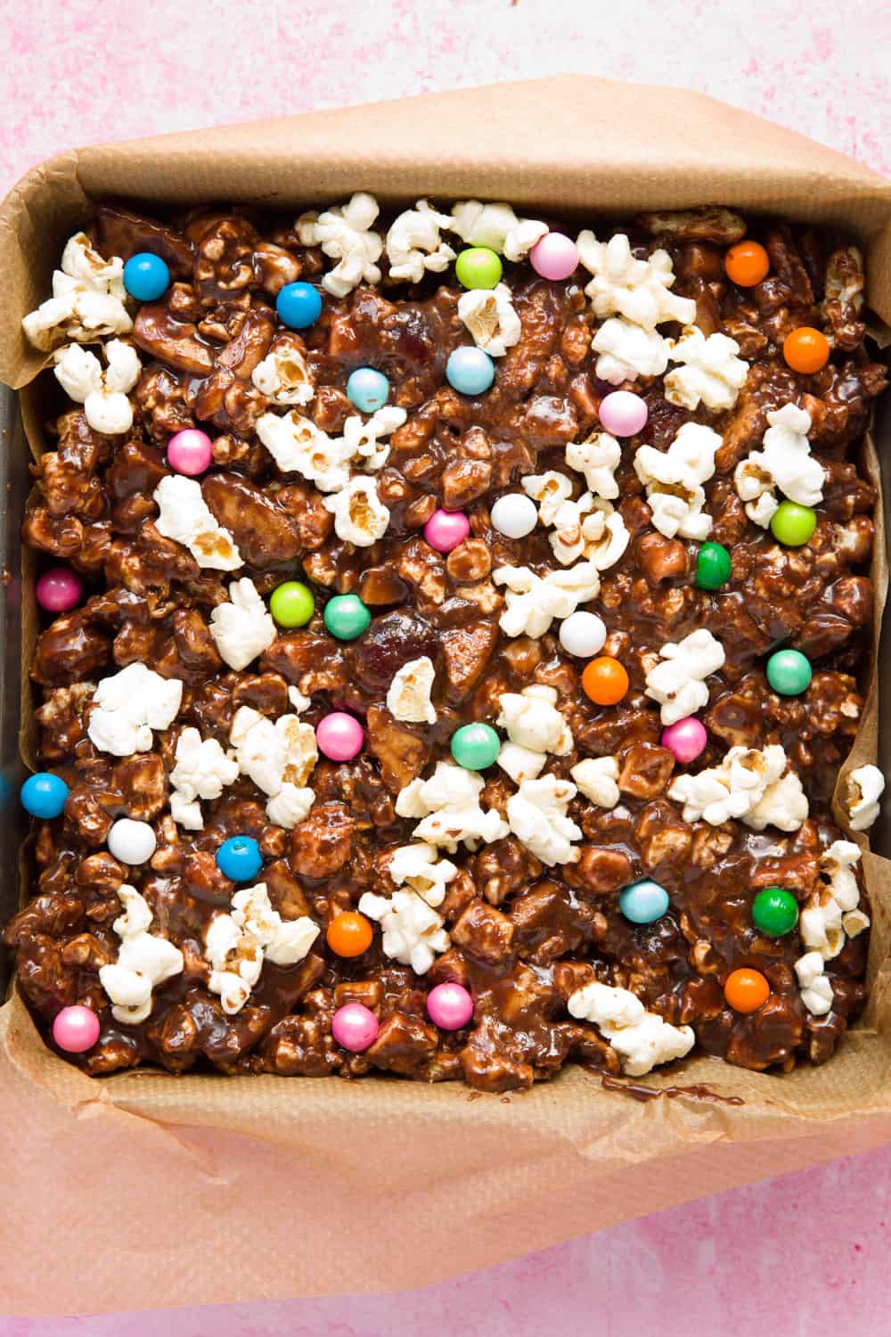 A slab of popcorn rocky road inside a square baking tin.
