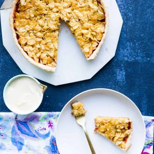A cornflake tart with a slice cut out.