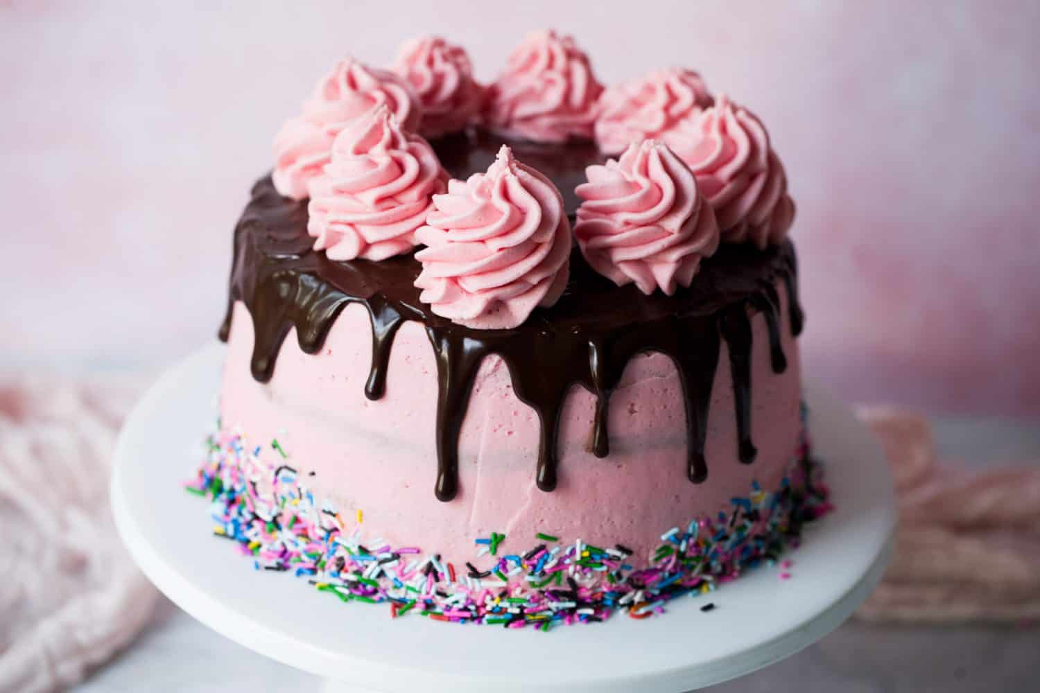 A DIY Drip cake with pink buttercream frosting. 