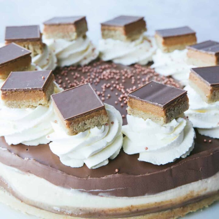 A Millionaire's Cheesecake with slices of Millionaire shortbread on top.