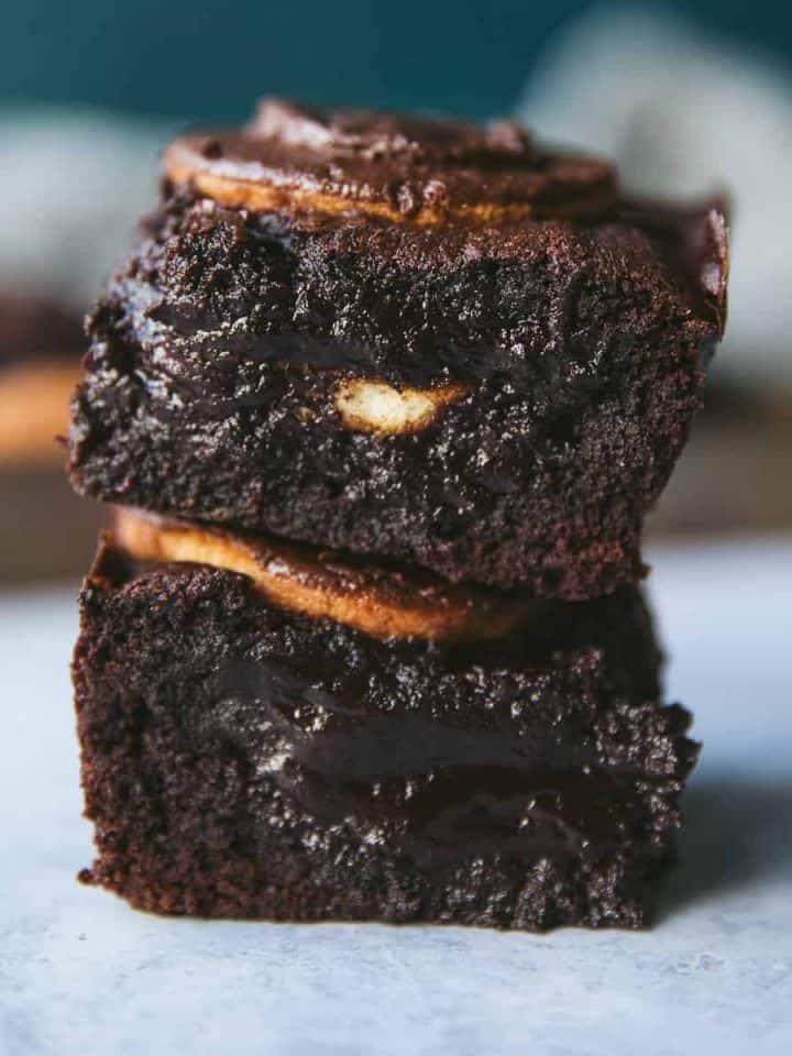 Fudgy Jaffa Cake Brownies stacked on top of each other.
