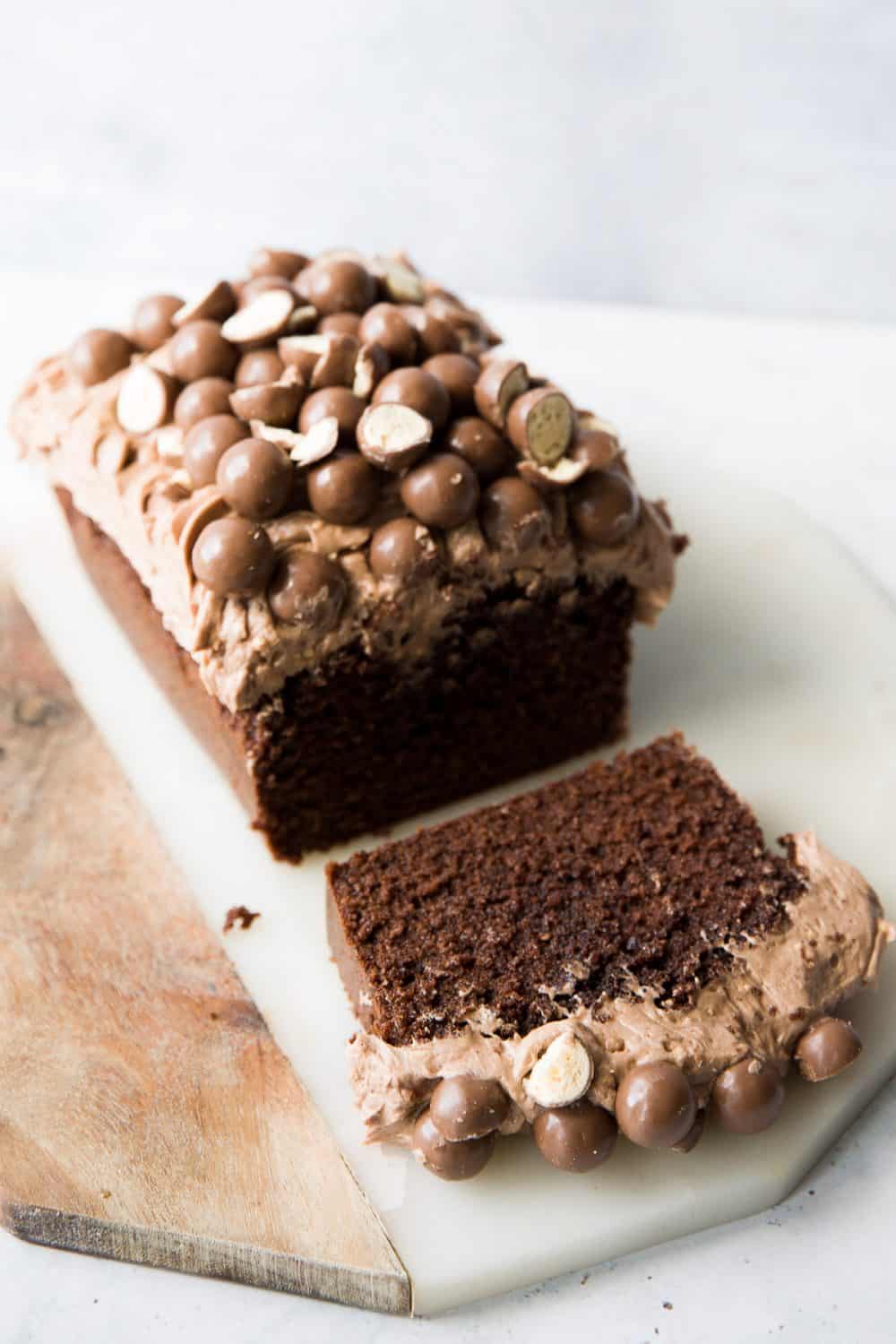 A chocolate loaf cake topped with buttercream and maltesers. 