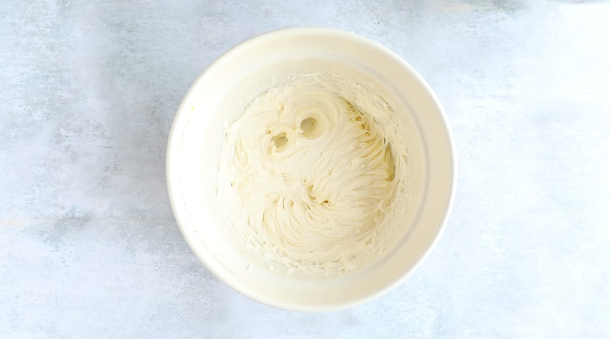 Cream cheese and icing sugar in a mixing bowl. It has been beaten until smooth and creamy. 