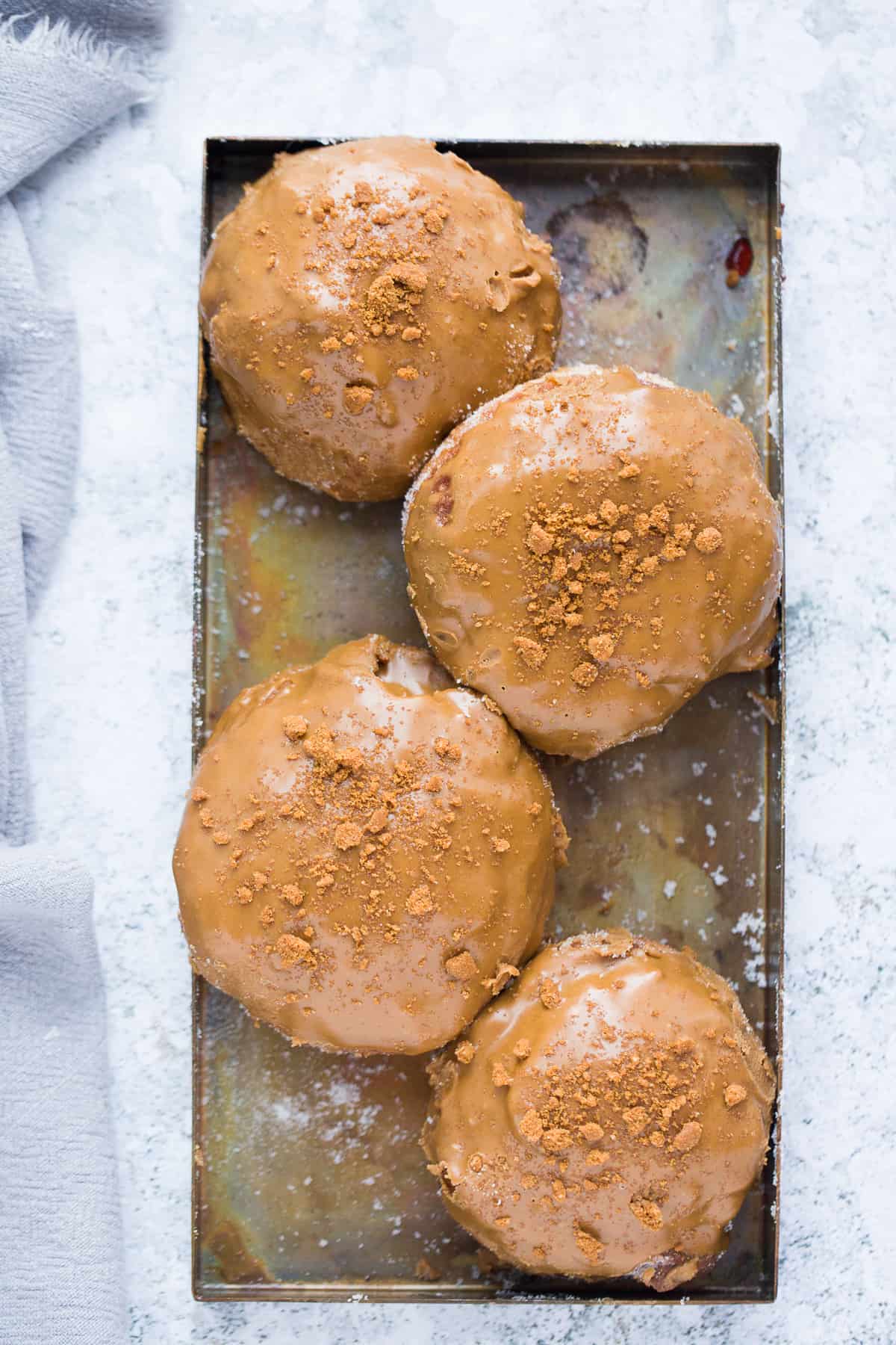 Cookie butter donuts on a baking tray. 