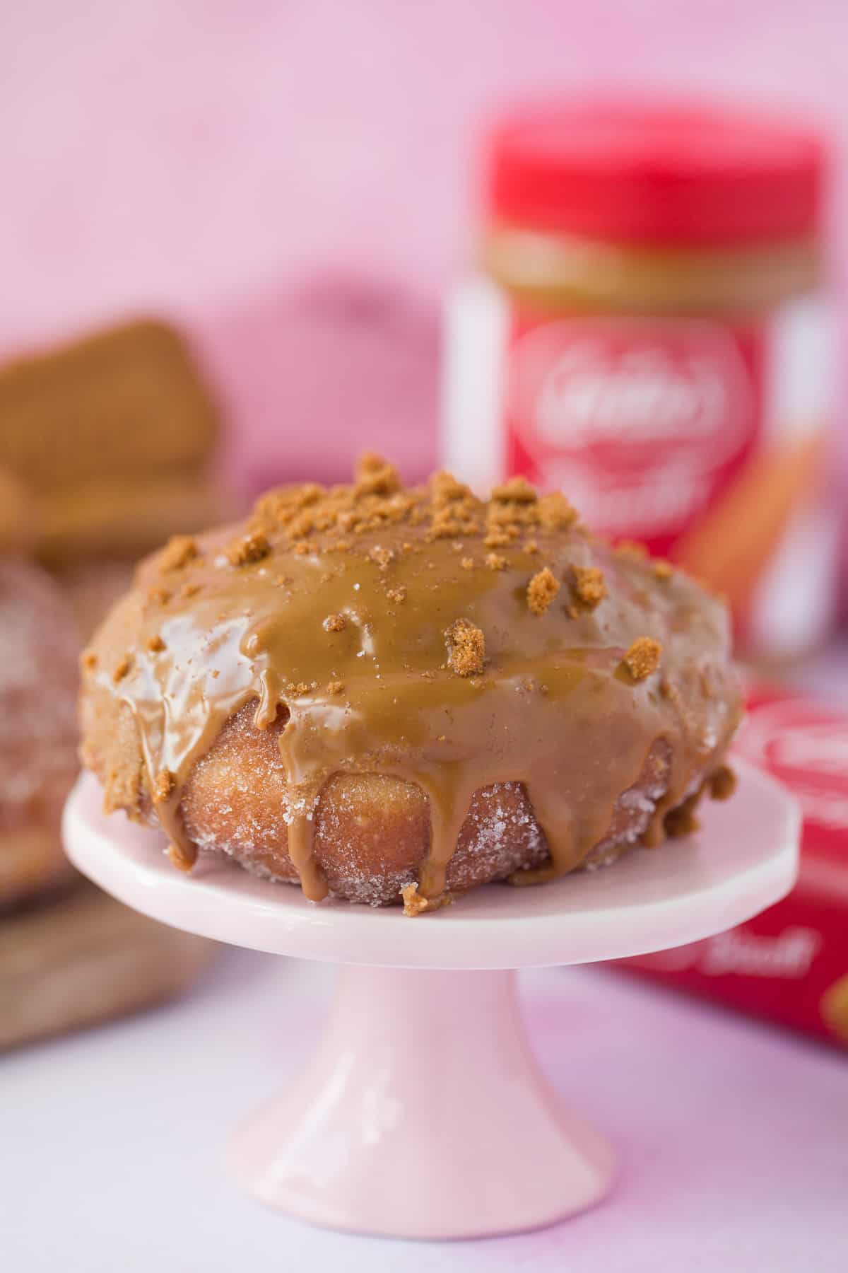 A doughnut with biscoff spread over the top and dripping down the sides. 