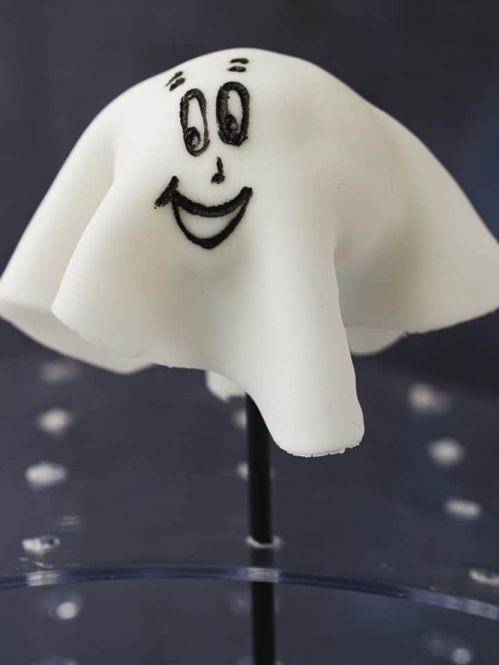 A cake pop covered in white fondant to make it look like a ghost.