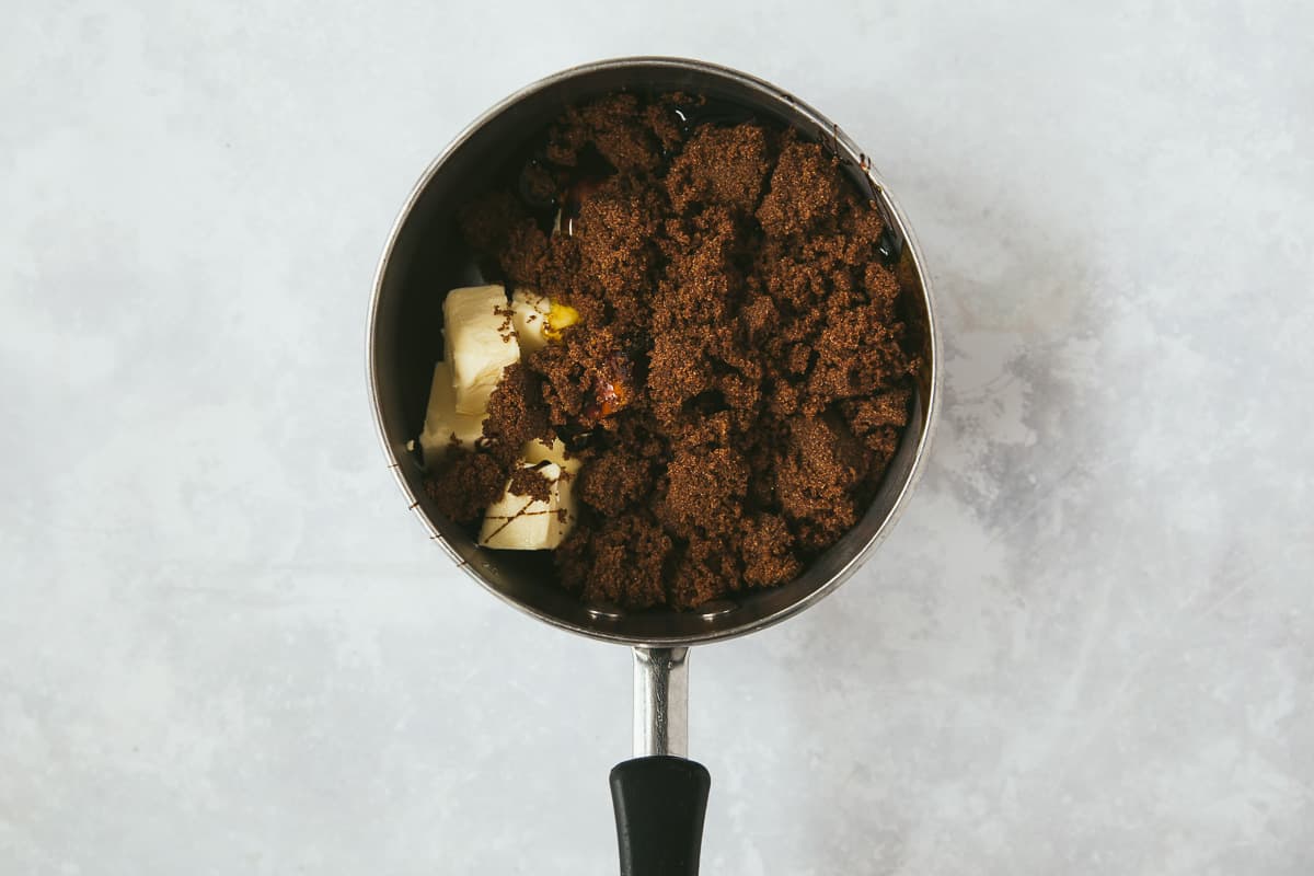 A saucepan containing butter, black treacle, golden syrup and dark brown sugar. 