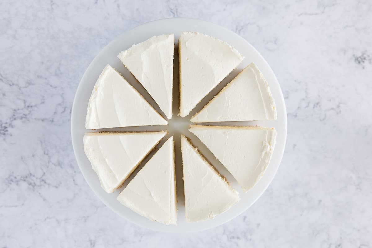 A no bake vanilla cheesecake that has been cut into 8 identical slices. 