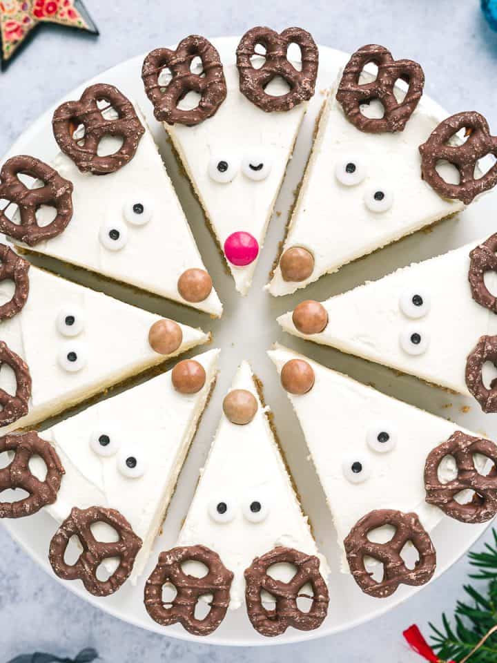 A cheesecake cut into 8 slices and decorated as Reindeer.