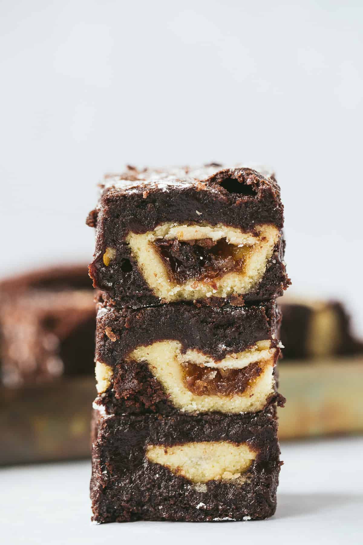 A stack of three chocolate brownies each with a mini mince pie baked inside. 