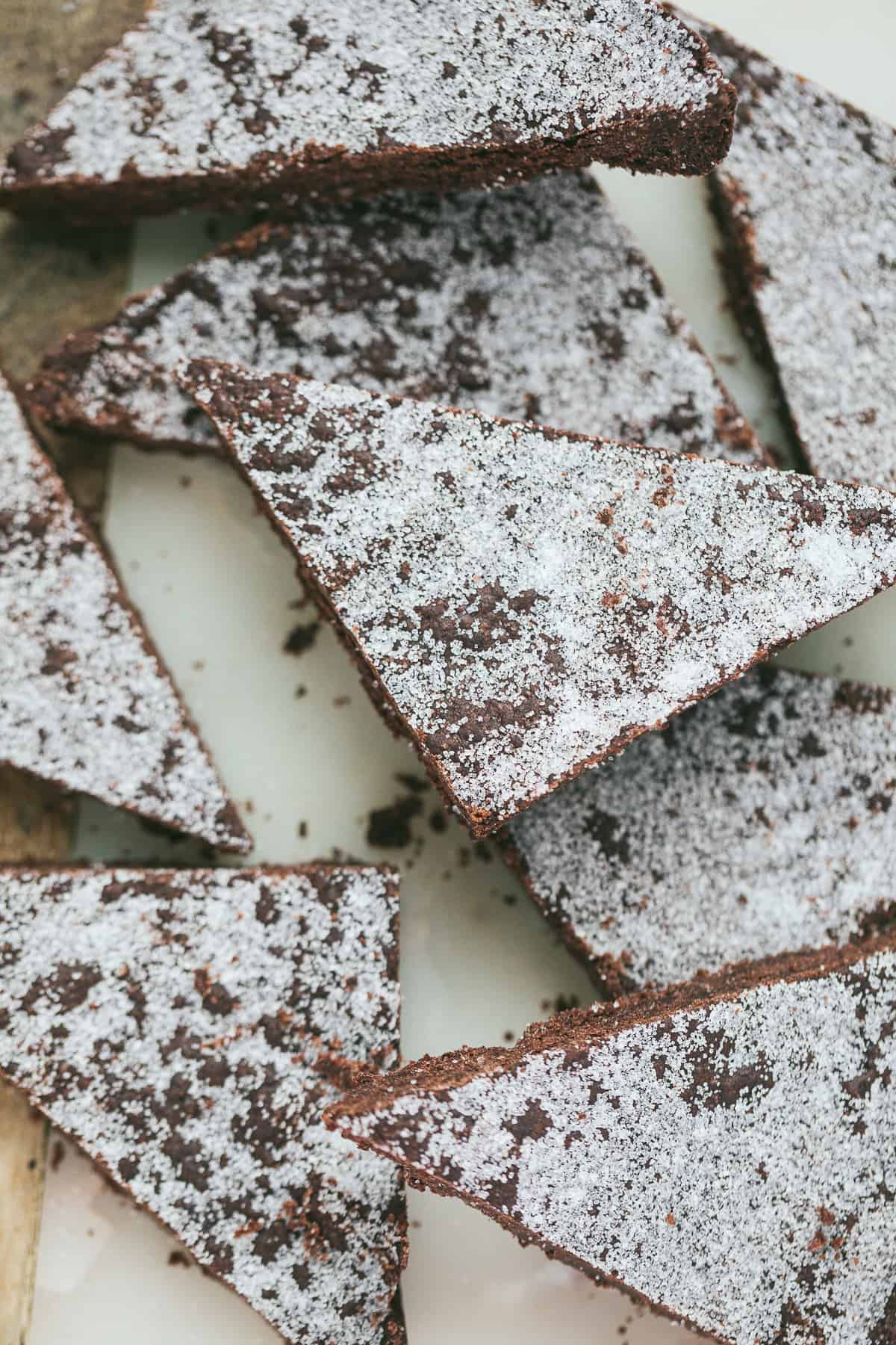 Slices of Chocolate Crunch cut into triangles and sprinkled with sugar. 