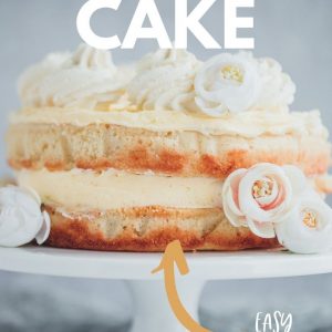 A lemon cake on a white cake stand Pinterest image with text overlay.
