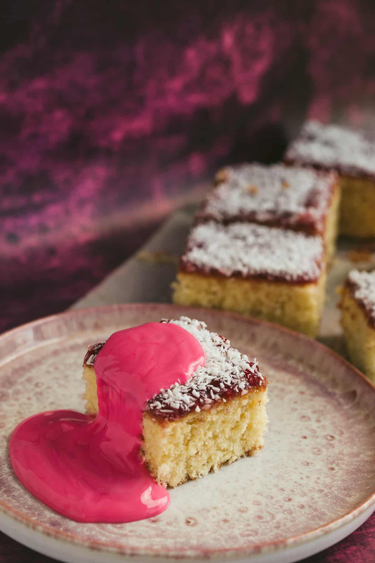 A slice of raspberry jam and coconut cake traybake 