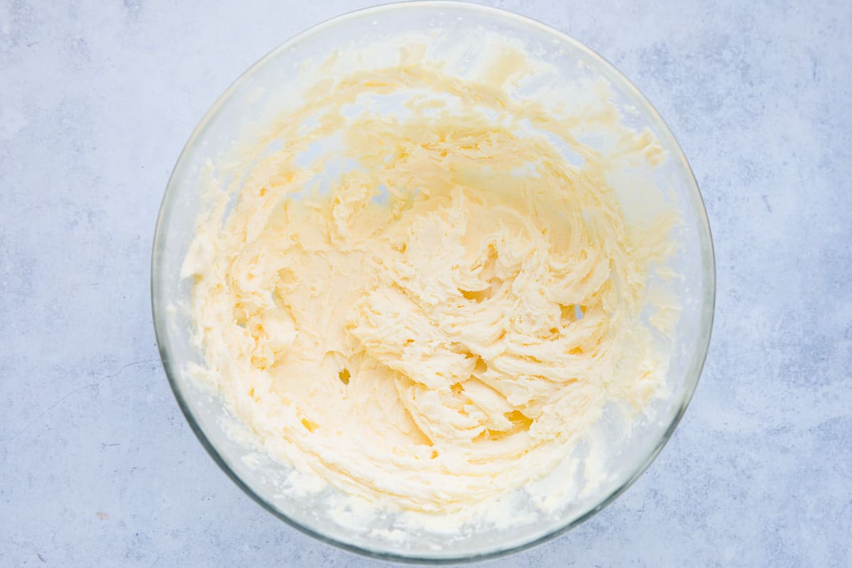 A bowl containing creamed butter and sugar. 