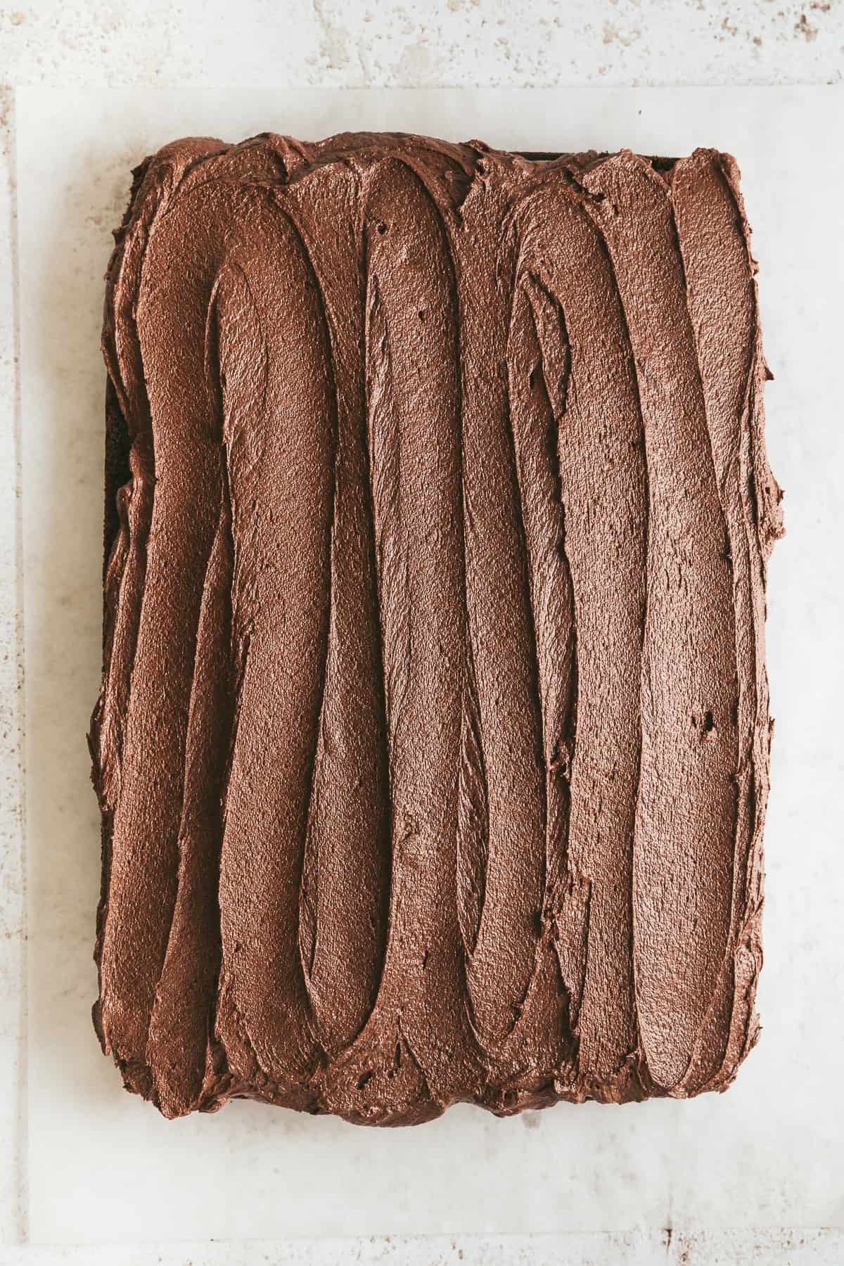 Chocolate buttercream icing on top of a cake. 