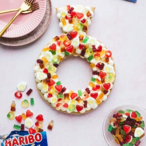 A cream Tart in a ring shape decorated with Haribo sweets.