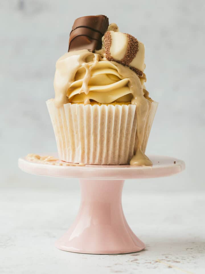 A Kinder Bueno Cupcake on a small pink cake stand.