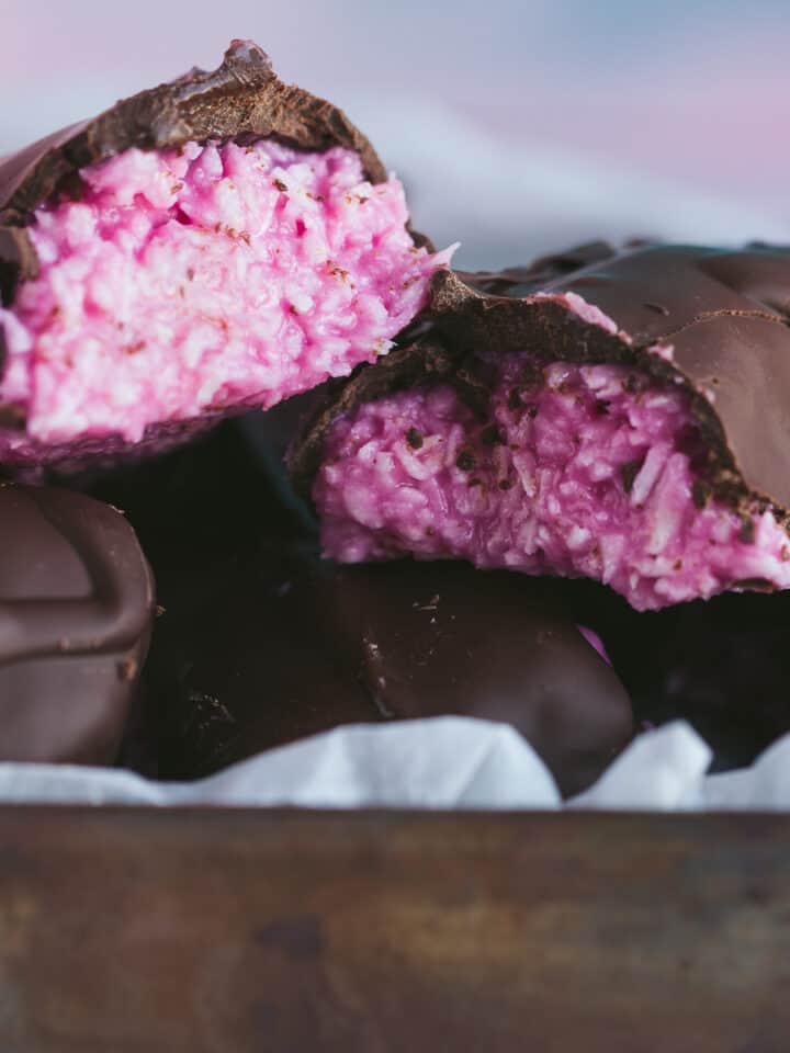 Raspberry Ruffle Bars that have been cut open to reveal the bright pink coconut inside.
