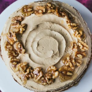 A coffee cake covered in coffee buttercream and walnut praline.
