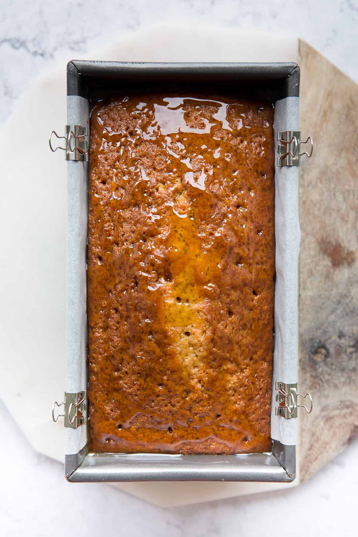 A baked Syrup loaf Cake that has just had syrup poured on top of it. 