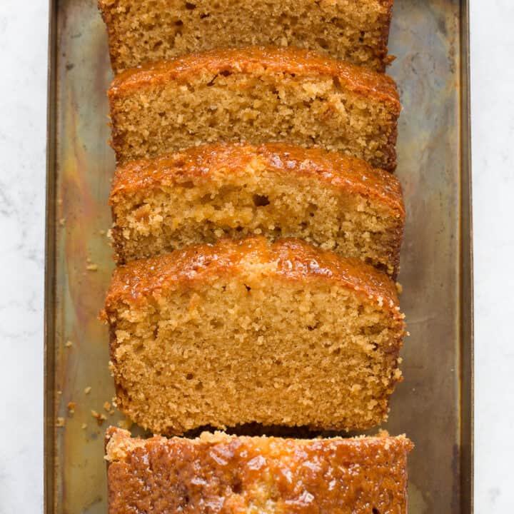 A golden syrup cake cut into slices.