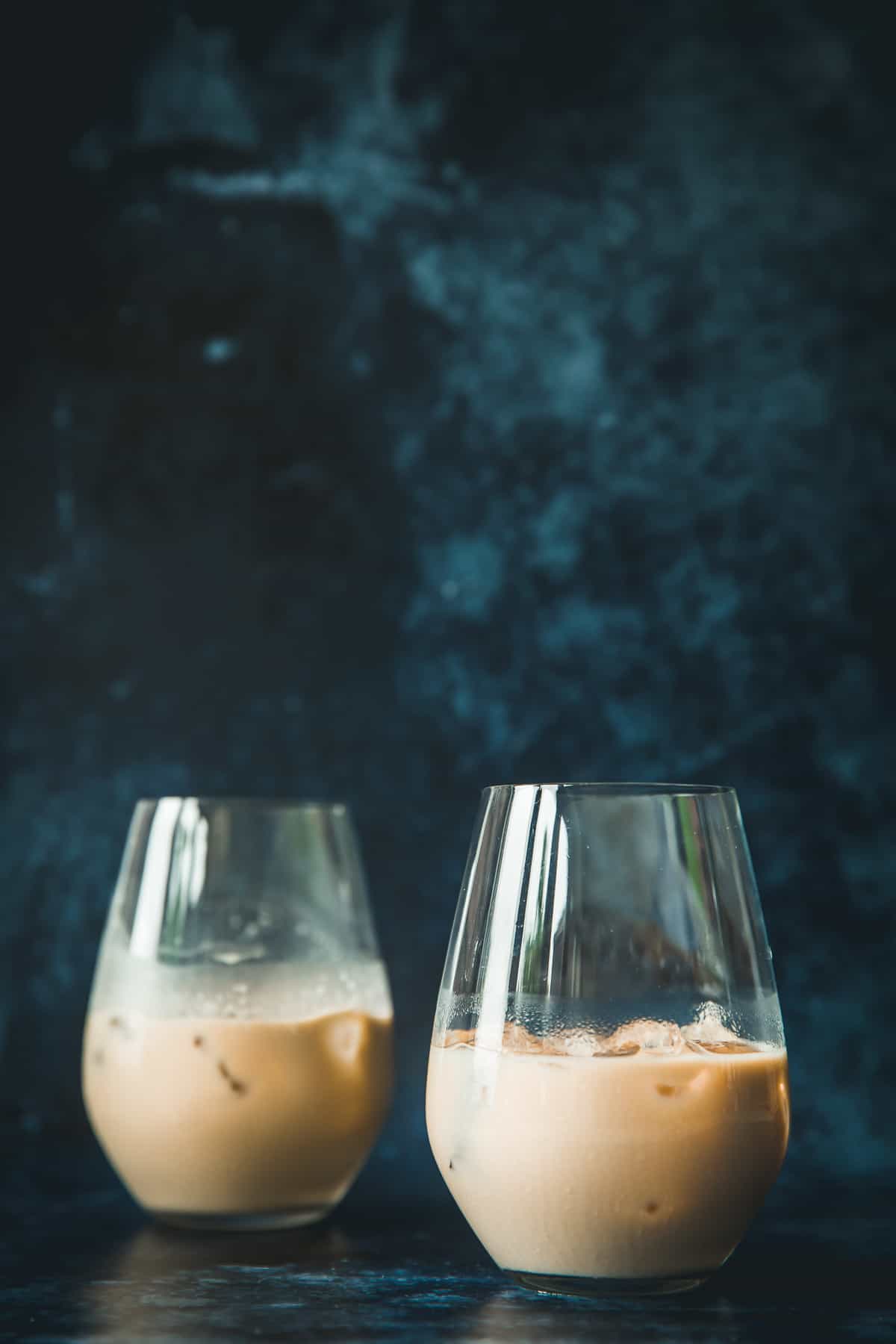 Two glasses filled with Baileys White Russian cocktails. 