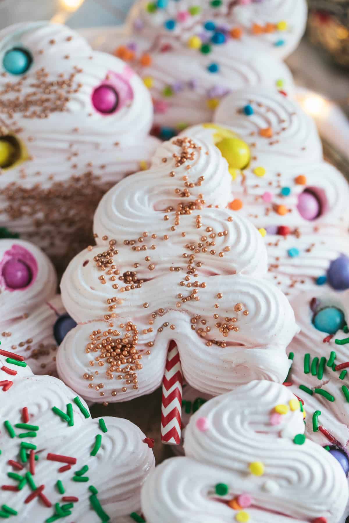 A close up image of a christmas tree cookie made from meringue. 